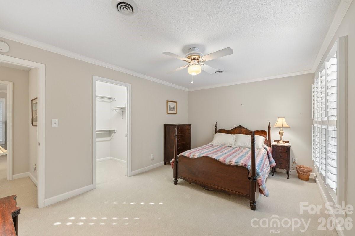 207 Lost Corner Road Morganton, NC 28655 - Photo 40 of 46 a spacious bedroom with a bed and a chandelier