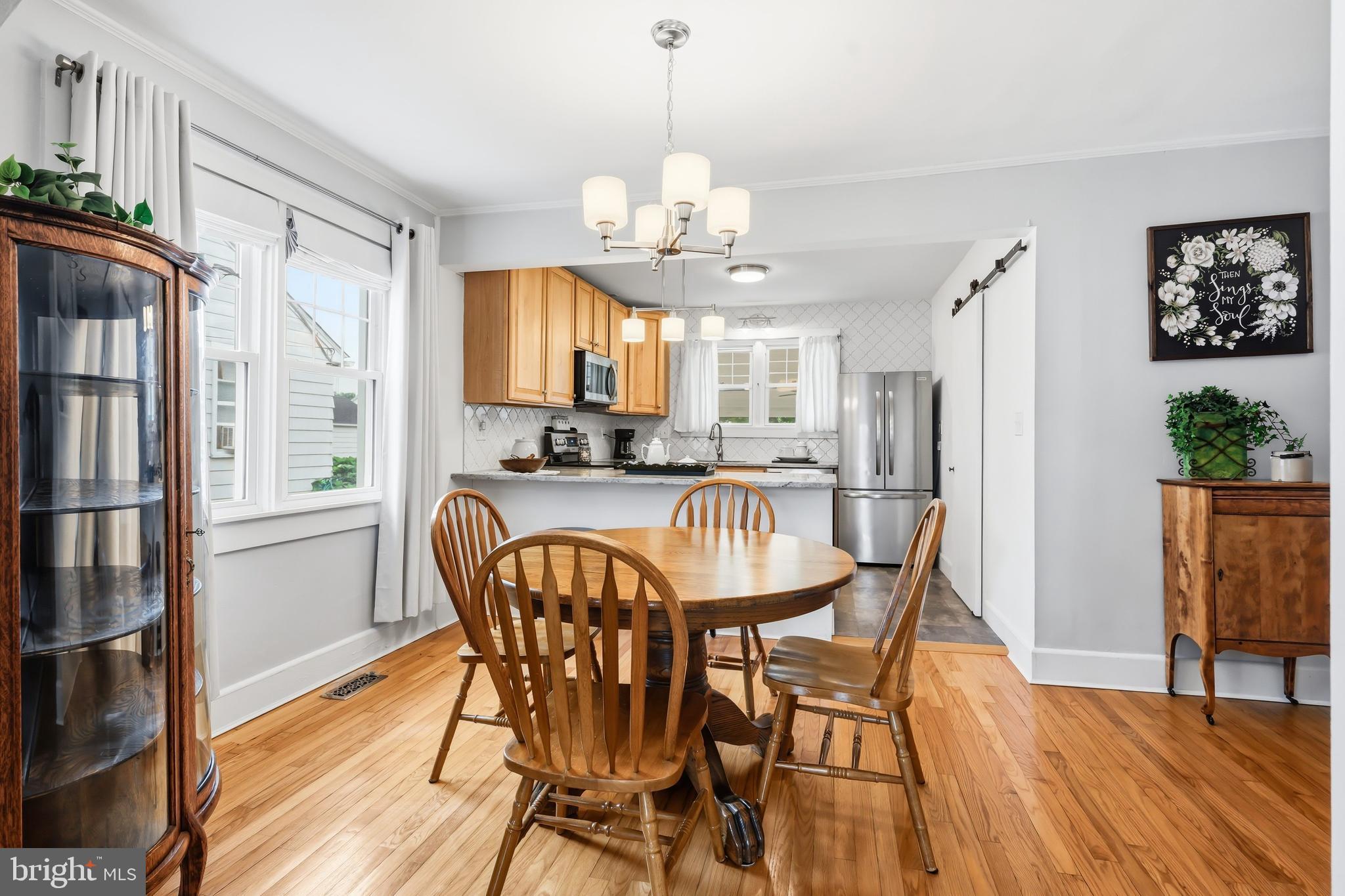 207 Crusader Road Cambridge, MD 21613 - Photo 20 of 76 a dining room with furniture a window and wooden floor