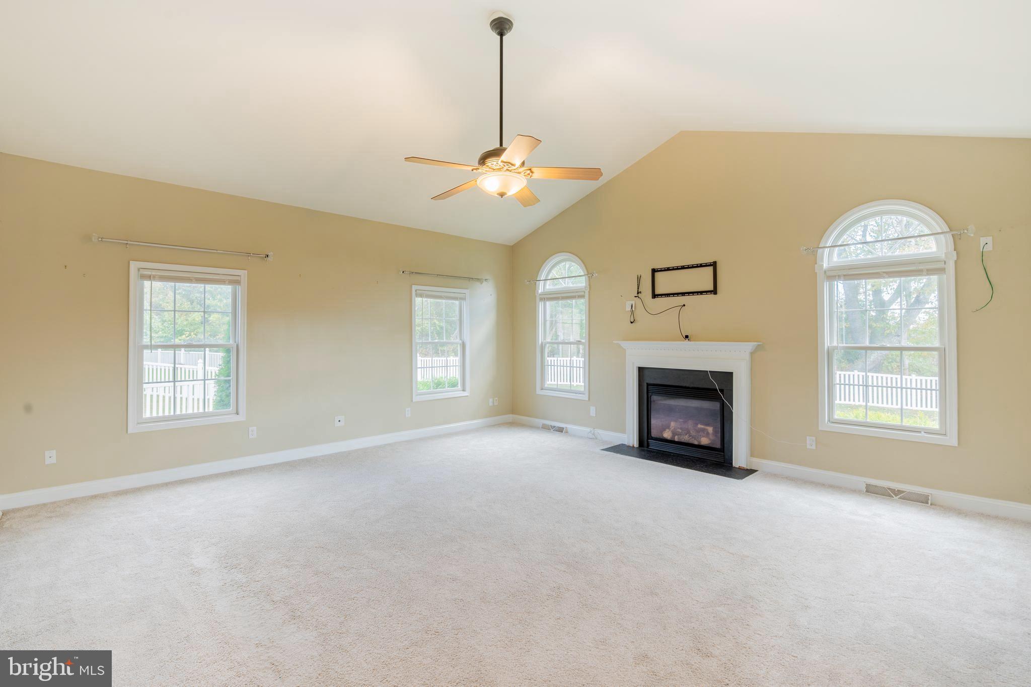 128 Jillian Court Dover, DE 19901 - Photo 17 of 45 a view of an empty room with a fireplace and a window