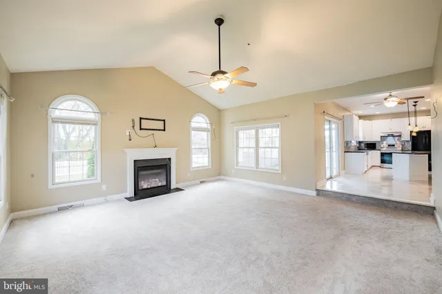 a view of an empty room with a fireplace