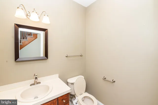 a bathroom with a toilet sink and mirror