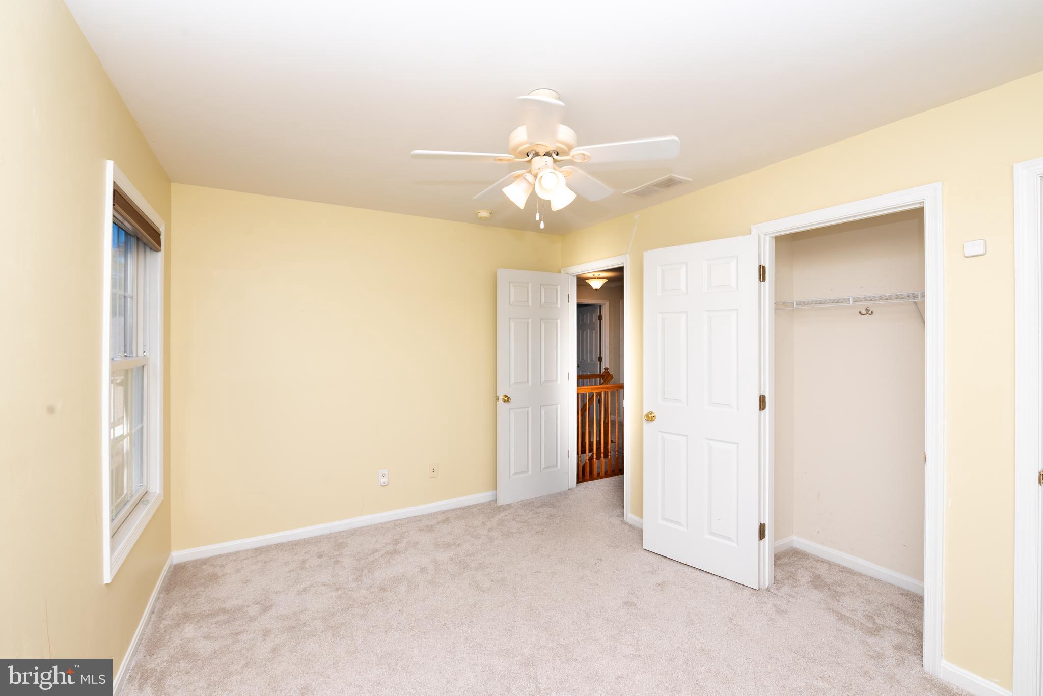 128 Jillian Court Dover, DE 19901 - Photo 30 of 45 an empty room with closet and a chandelier fan