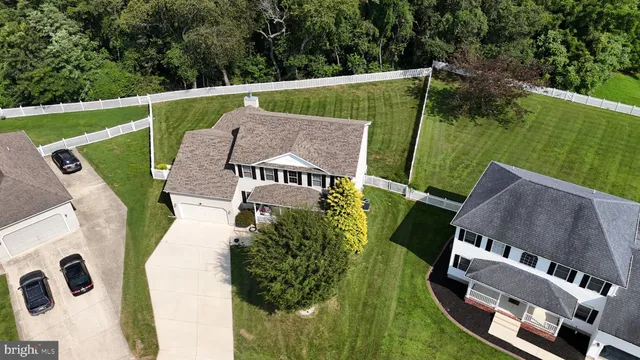 an aerial view of a house with a big yard