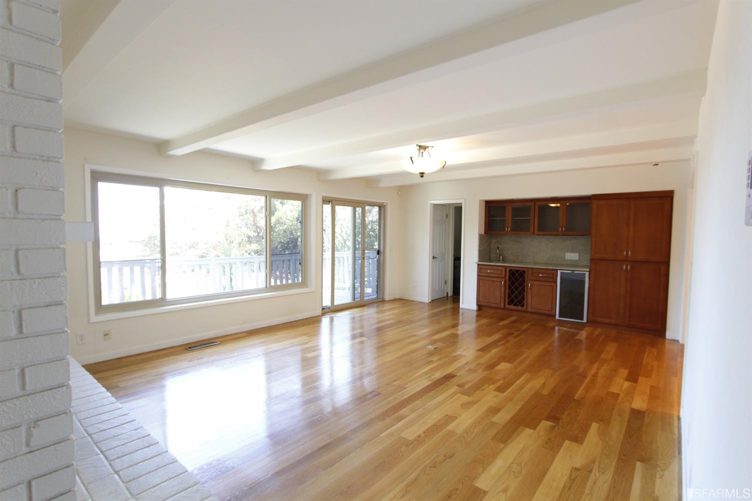 316 Alberta Way Hillsborough, CA 94010 - Photo 12 of 31 an empty room with wooden floor and large windows