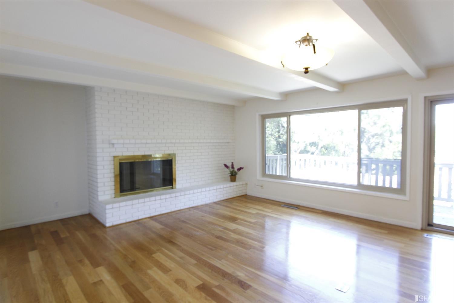 316 Alberta Way Hillsborough, CA 94010 - Photo 14 of 31 a view of an empty room with a fireplace and a window