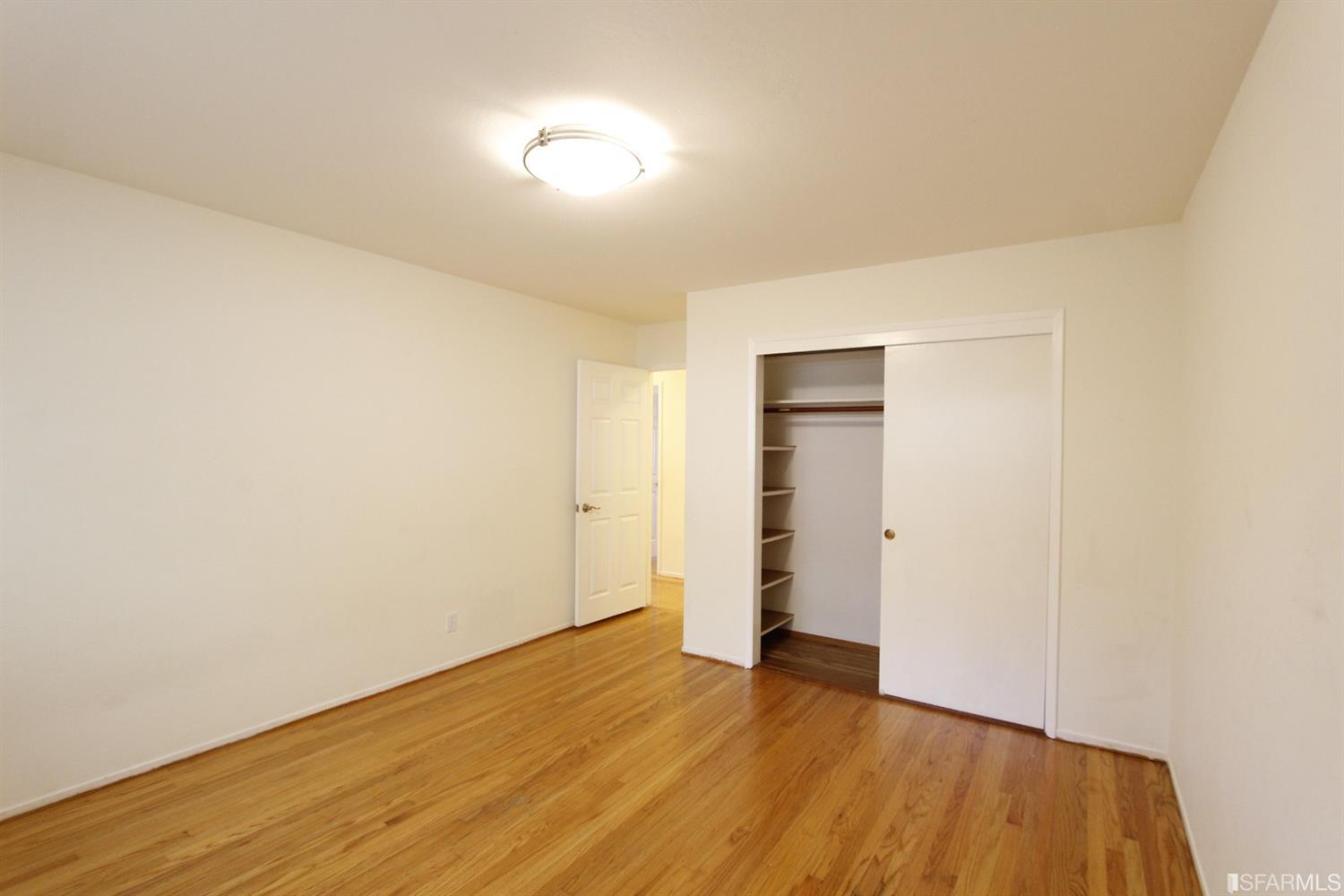 316 Alberta Way Hillsborough, CA 94010 - Photo 18 of 31 a view of an empty room with wooden floor and closet