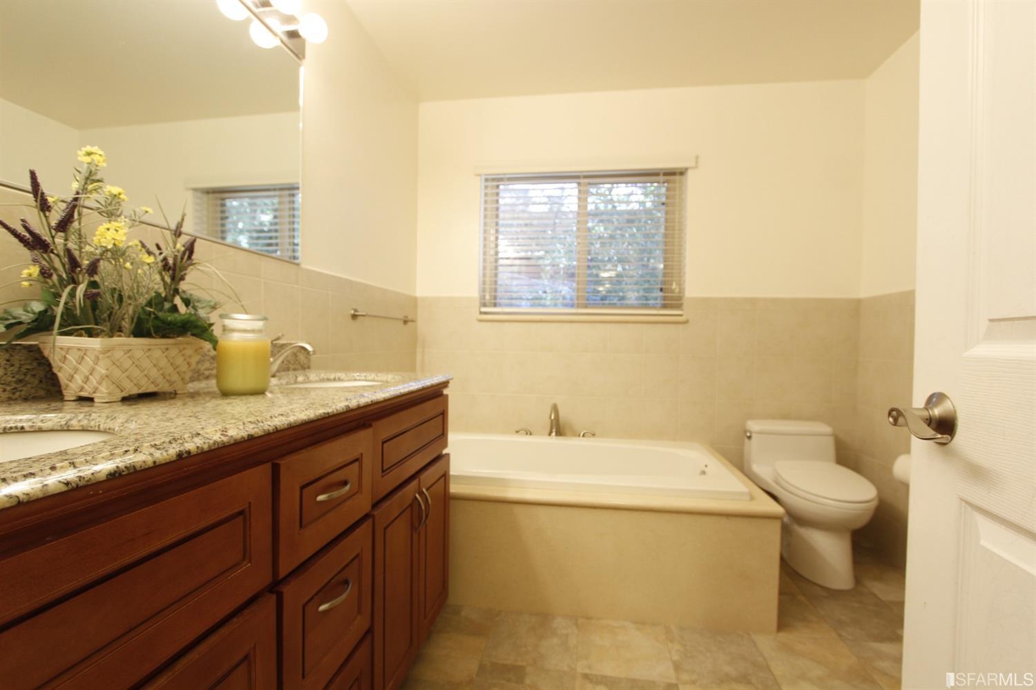 316 Alberta Way Hillsborough, CA 94010 - Photo 22 of 31 a bathroom with a granite countertop toilet a sink and a mirror