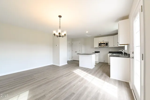 a view of a kitchen with wooden floor
