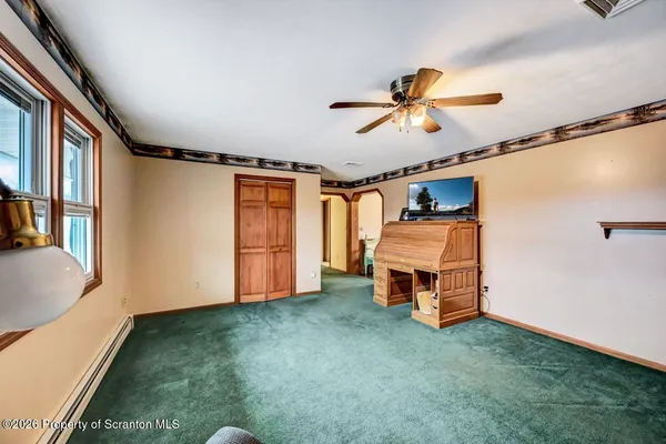 a view of a livingroom with wooden floor and closet area