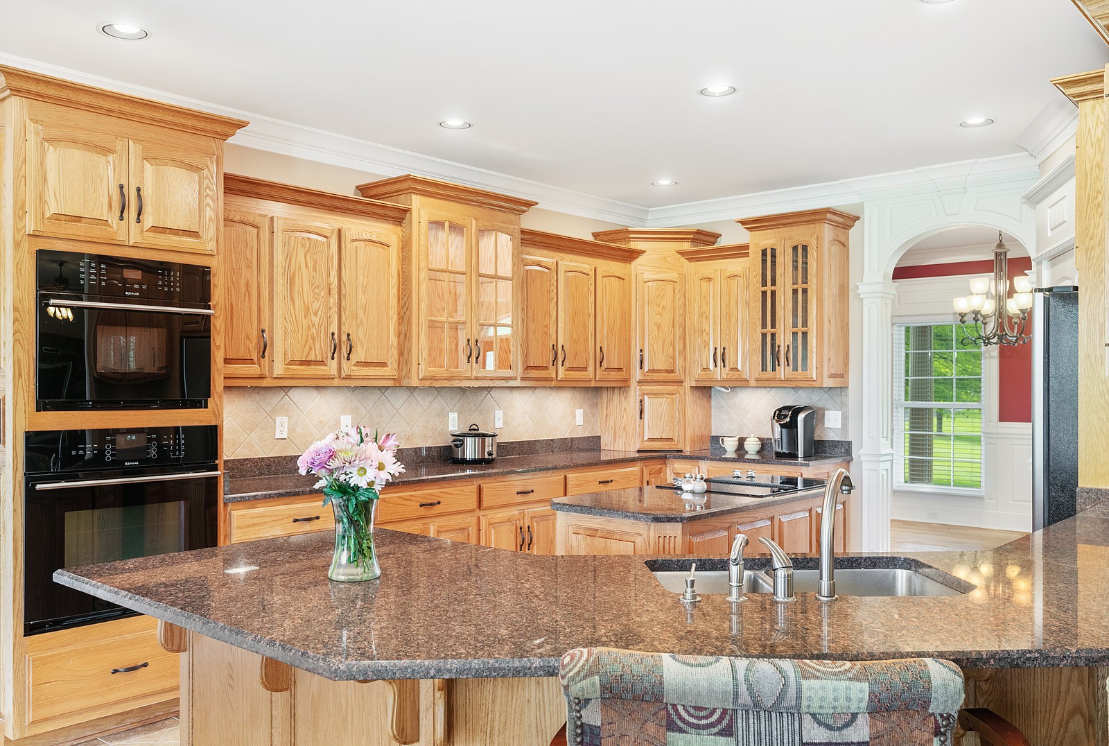 288 Lee Road Cottontown, TN 37048 - Photo 12 of 47 a kitchen with kitchen island granite countertop a stove top oven a sink a dining table and chairs