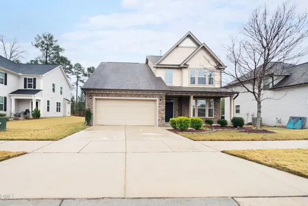 a front view of a house with a yard and garage