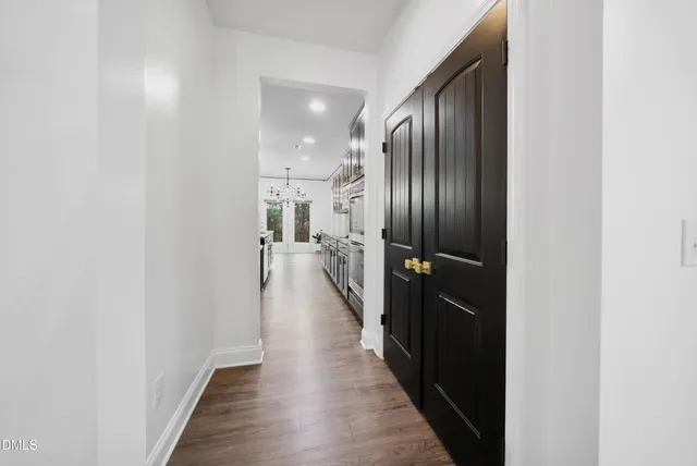 a view of hallway with wooden floor