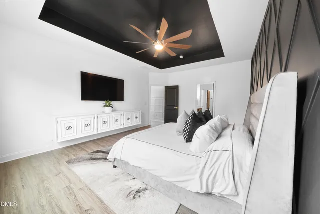 a bedroom with a bed and a flat screen tv