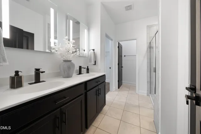 a kitchen with stainless steel appliances a sink and a refrigerator