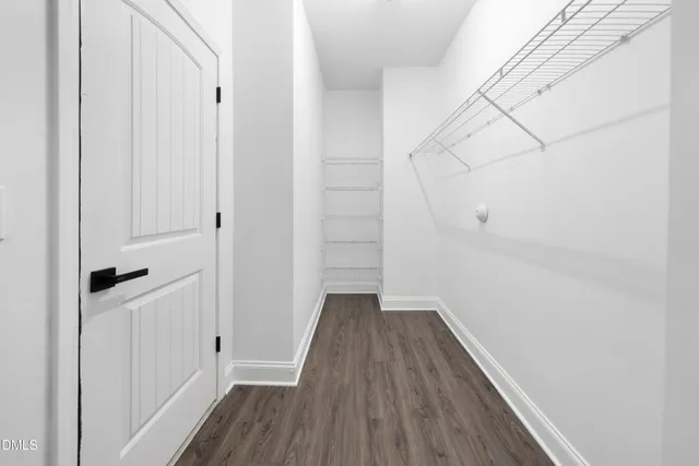 a view of a room with wooden floor