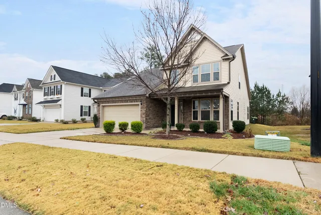 a front view of a house with a yard and countertop lots of windows