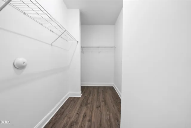 a view of a room with wooden floor and white walls