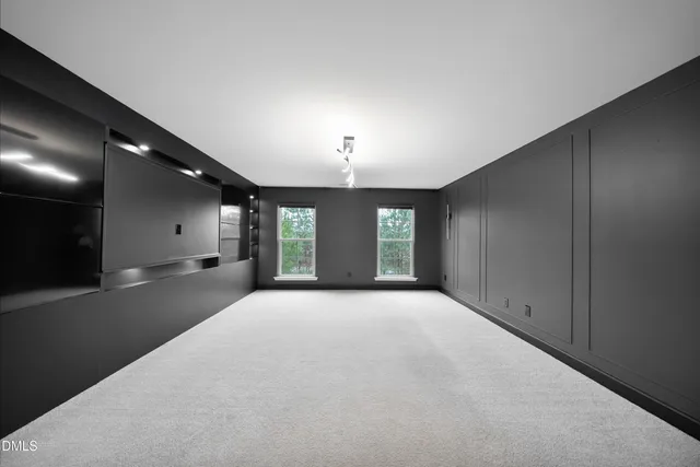 a large bed in a spacious bedroom with a large mirror