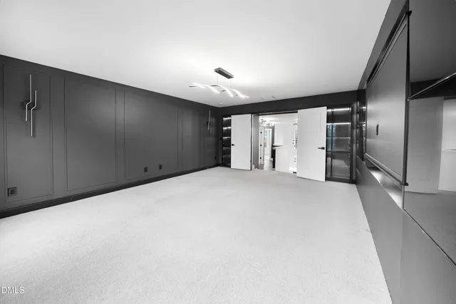 a large room with closet and windows