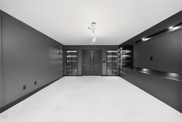 an empty room with ceiling fan and window