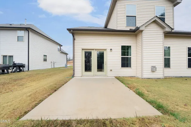 a view of a house with pool and yard