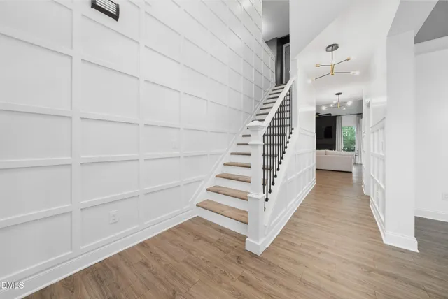 a view of a hallway with wooden floor and entryway