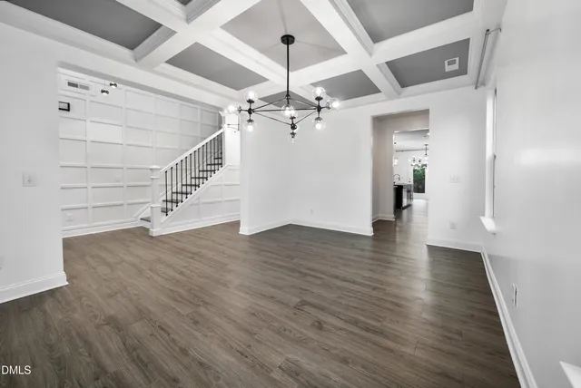 wooden floor in an empty room with a ceiling fan