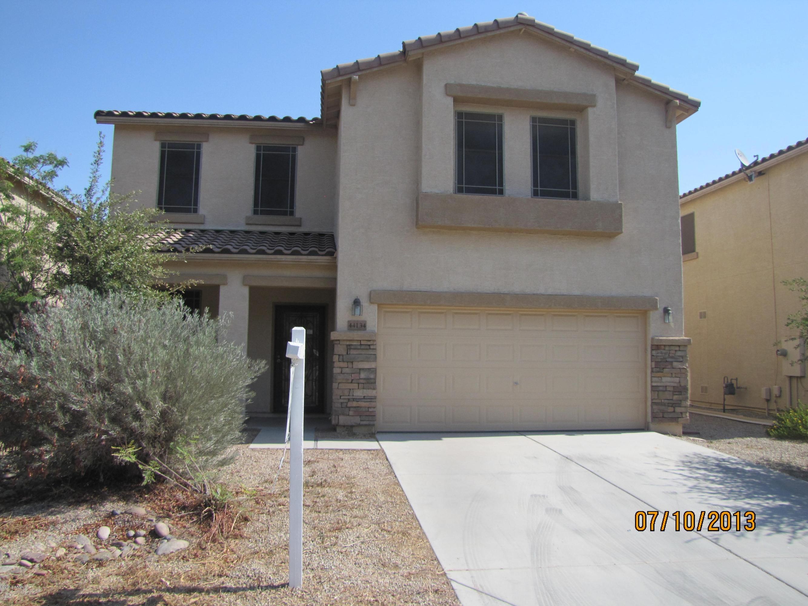 44134 Roth Road Maricopa, AZ 85138 - Photo 1 of 13 a front view of a house with garden