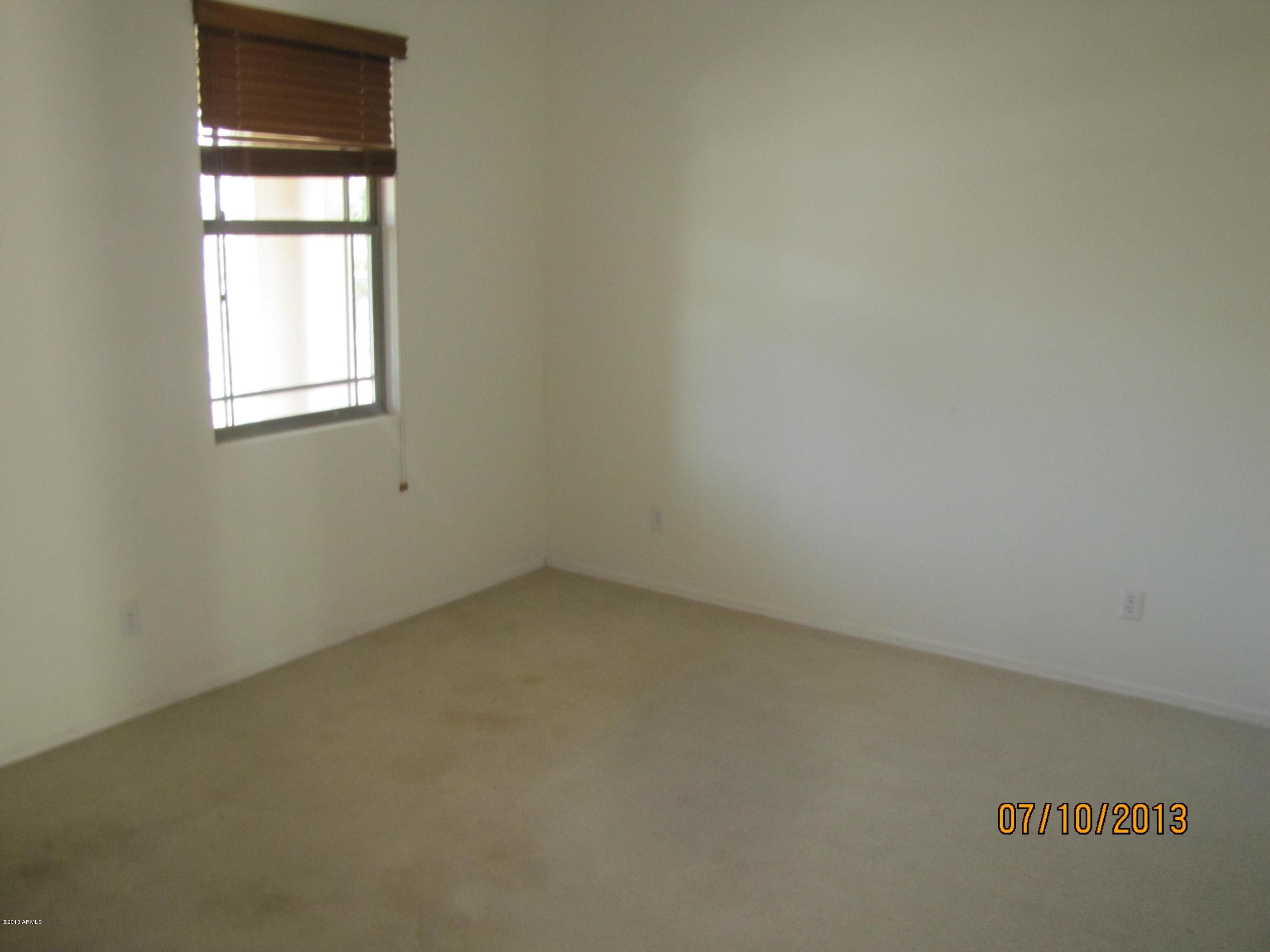 44134 Roth Road Maricopa, AZ 85138 - Photo 2 of 13 an empty room with a window