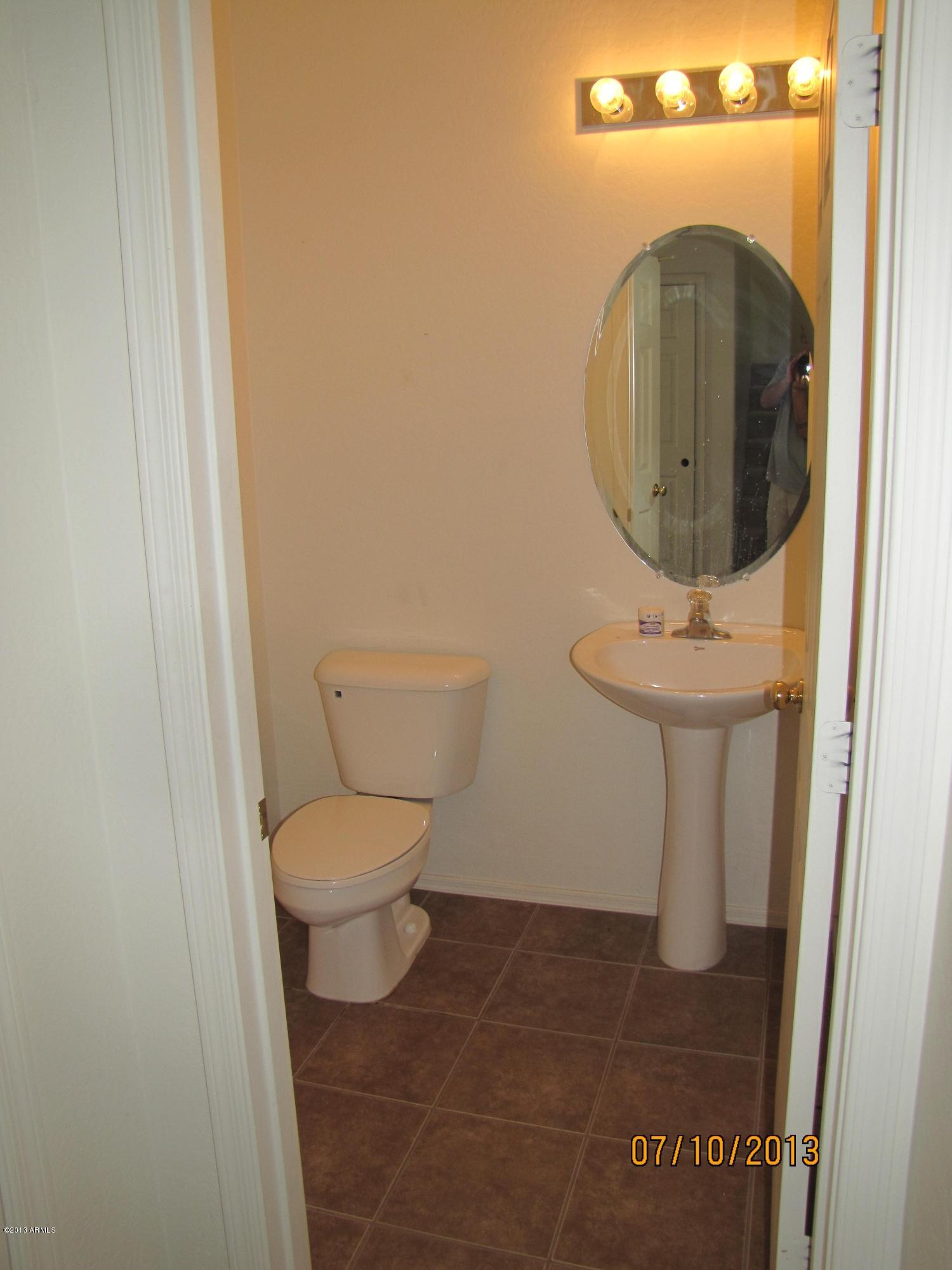 44134 Roth Road Maricopa, AZ 85138 - Photo 5 of 13 a bathroom with a toilet and a sink