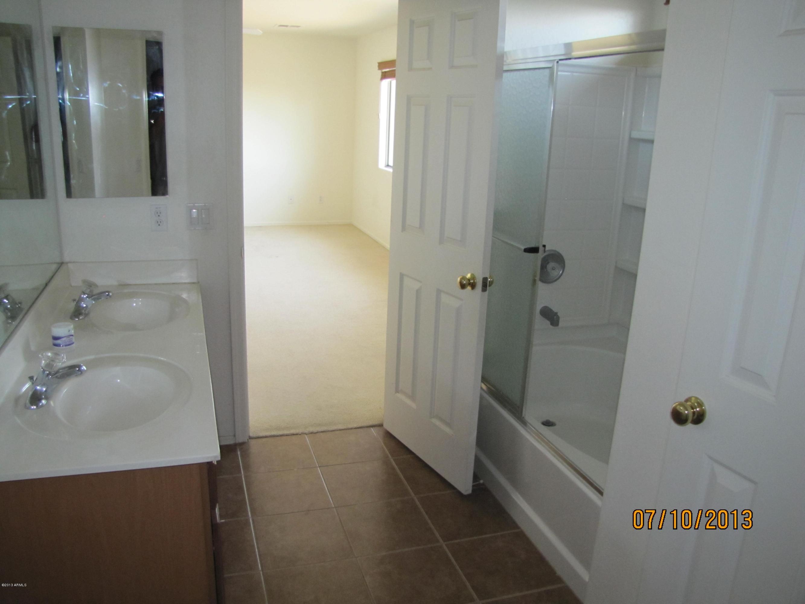 44134 Roth Road Maricopa, AZ 85138 - Photo 8 of 13 a bathroom with a sink and shower