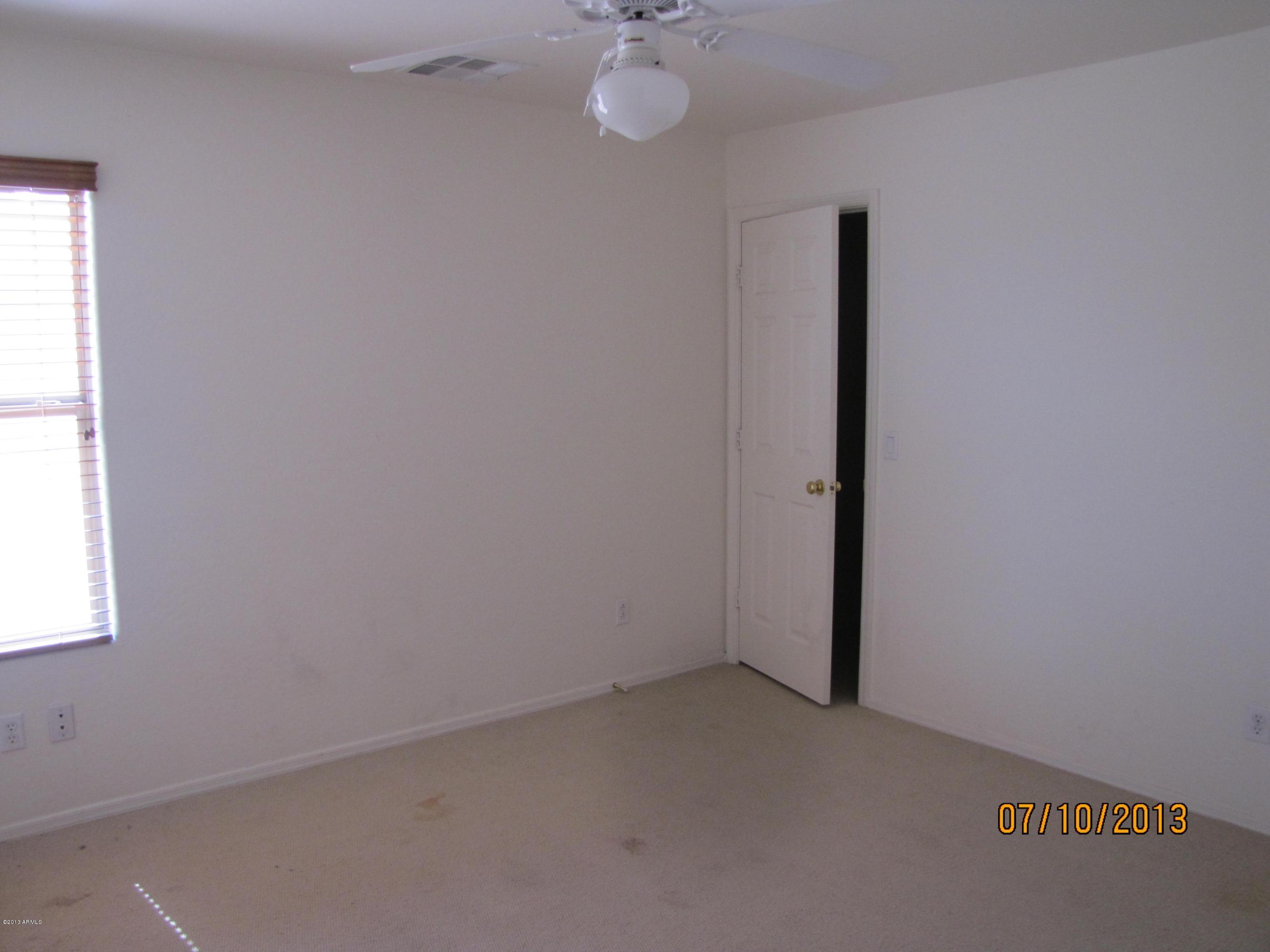 44134 Roth Road Maricopa, AZ 85138 - Photo 9 of 13 an empty room with a window