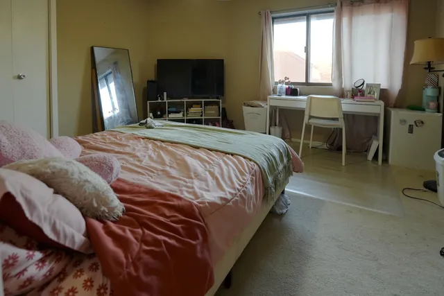 a view of a workspace with furniture and a window