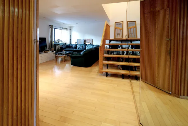 a bed sitting in a spacious bedroom next to a window