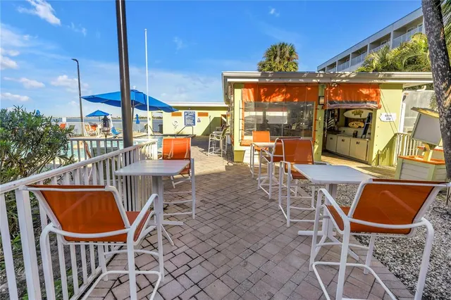 a building outdoor space with patio furniture and wooden floor