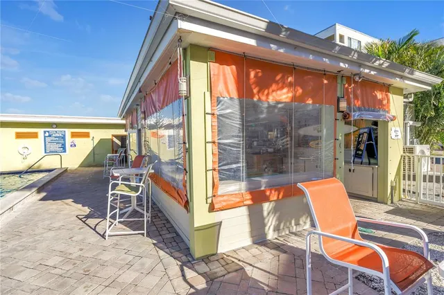 a view of the patio with dining space and trees around