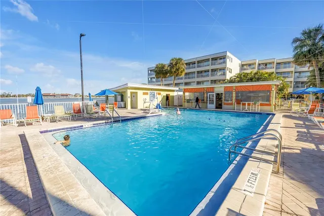a view of a swimming pool with an outdoor seating space