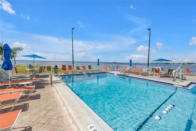 swimming pool view with outdoor seating