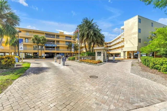 a view of a building with a yard and plants