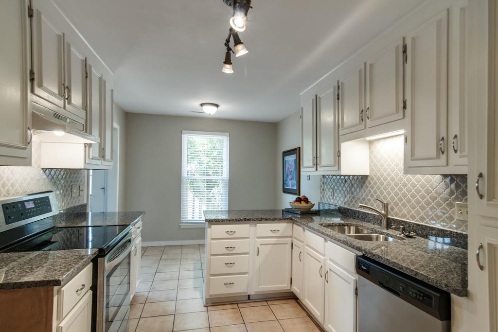 931 General George Patton Road Nashville, TN 37221 - Photo 2 of 22 a kitchen with stainless steel appliances granite countertop a sink stove and cabinets