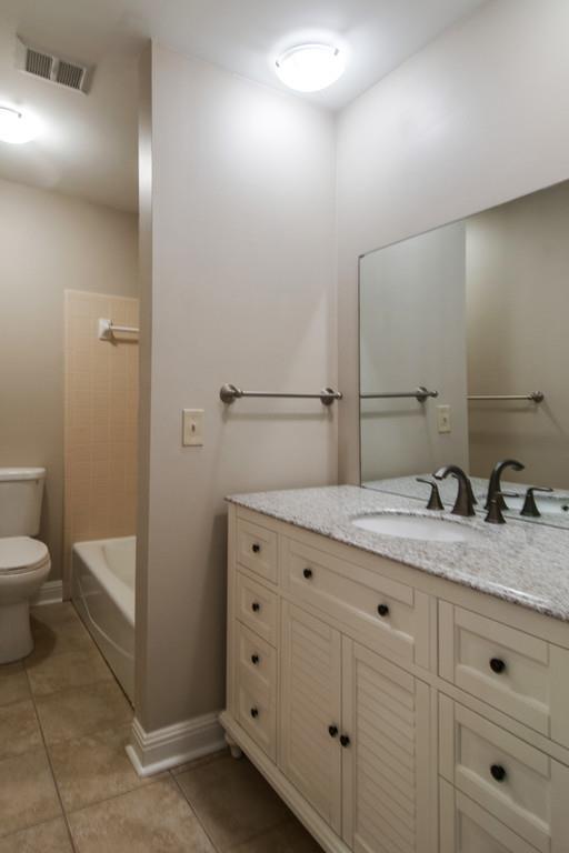 931 General George Patton Road Nashville, TN 37221 - Photo 17 of 22 a bathroom with a granite countertop sink and a mirror