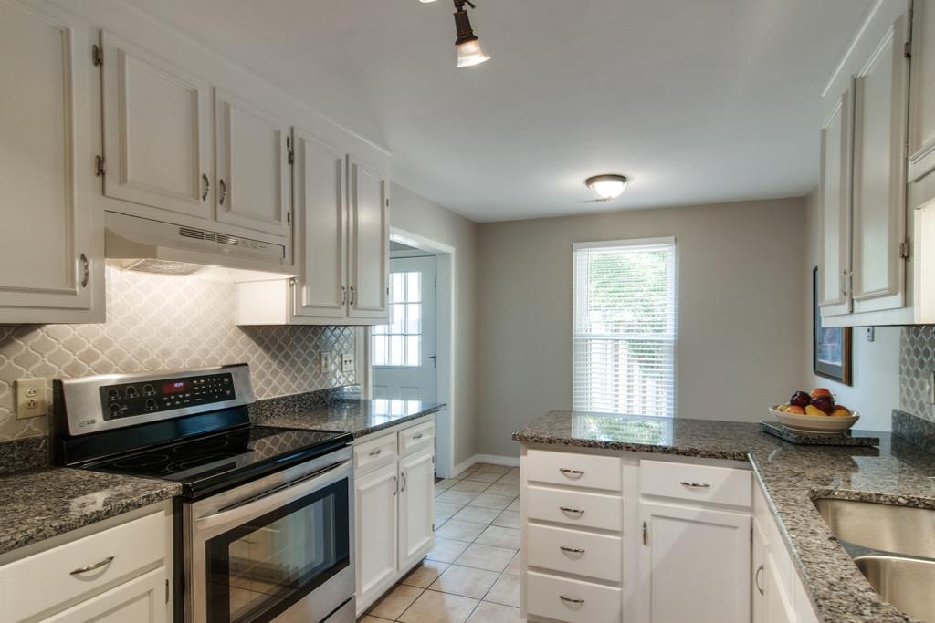 931 General George Patton Road Nashville, TN 37221 - Photo 7 of 22 a kitchen with granite countertop a stove sink and cabinets