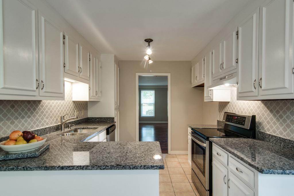931 General George Patton Road Nashville, TN 37221 - Photo 8 of 22 a kitchen with granite countertop a stove a sink and a granite counter tops