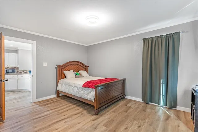 a bedroom with a bed and a large window