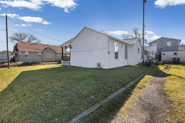 a view of a house with a yard and porch