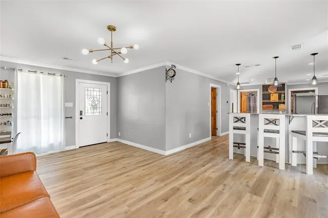 a living room with furniture a wooden floor and a window