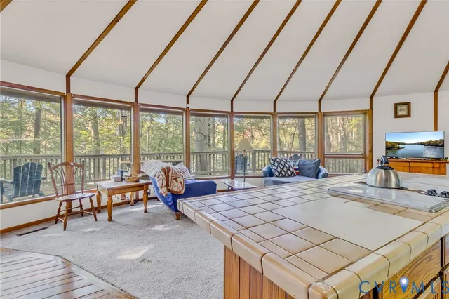 a living room with furniture a rug and white walls
