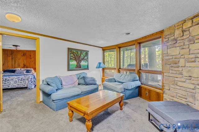 a living room with furniture and a floor to ceiling window