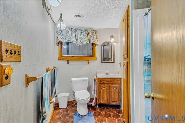 a bathroom with a toilet sink shower and mirror