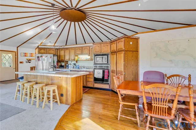 a dining room with furniture and a rug